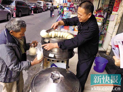 朱大哥在向流浪汉免费派发馒头。 新快报记者 杨英杰/摄