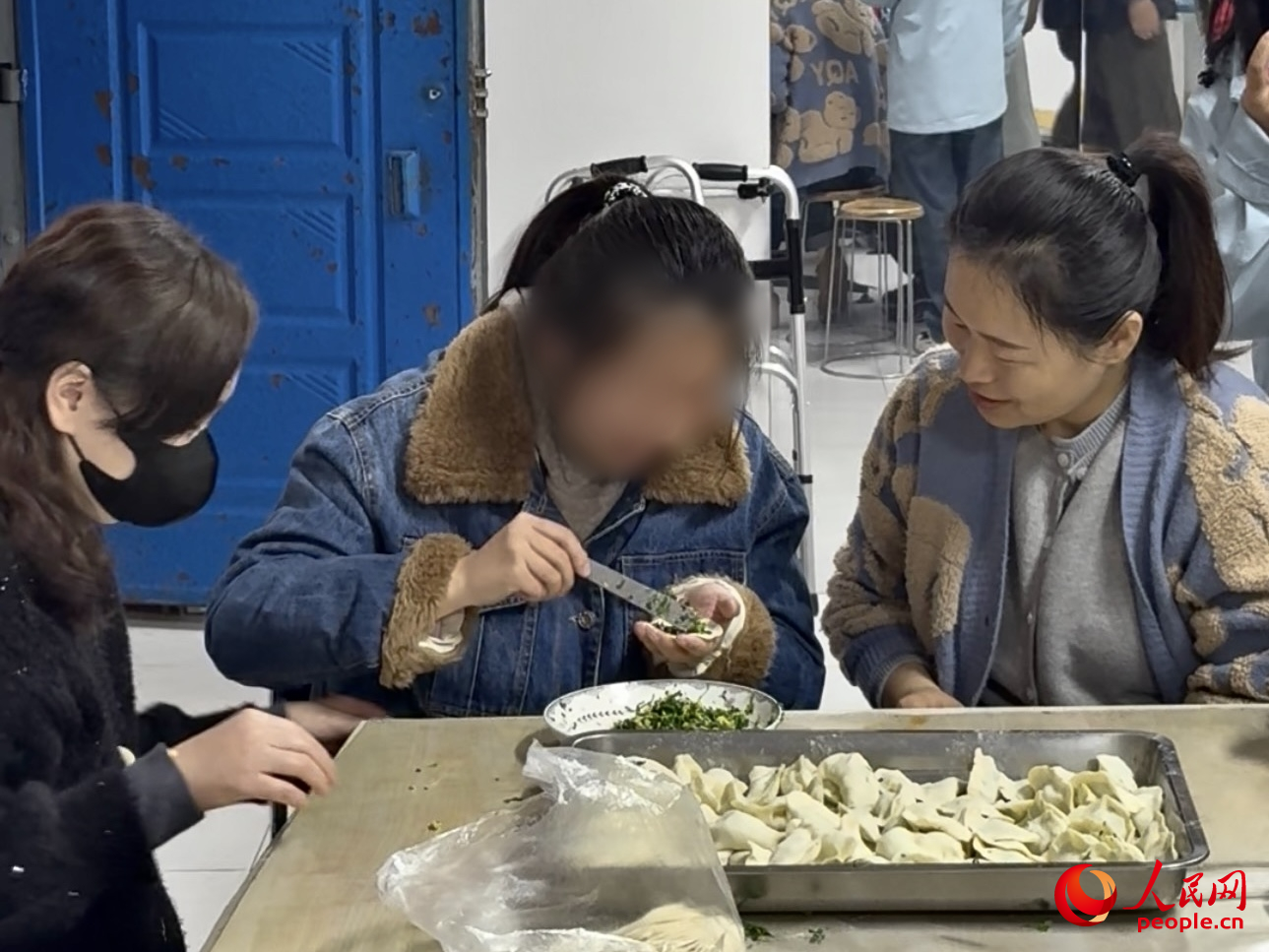 物业工作人员和李妍一起包饺子。人民网 陈叶欣摄